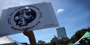 BOSTON - SEPTEMBER 17: A sign in support of Question 4 is raised in the air during the Boston Freedom Rally on Boston Common in Boston on Sept. 17, 2016. Tens of thousands of people were expected to attend the two-day rally, which has gathered annually for over two decades. It includes musical acts and political messages in support of the legalization of marijuana. (Photo by Craig F. Walker/The Boston Globe via Getty Images)